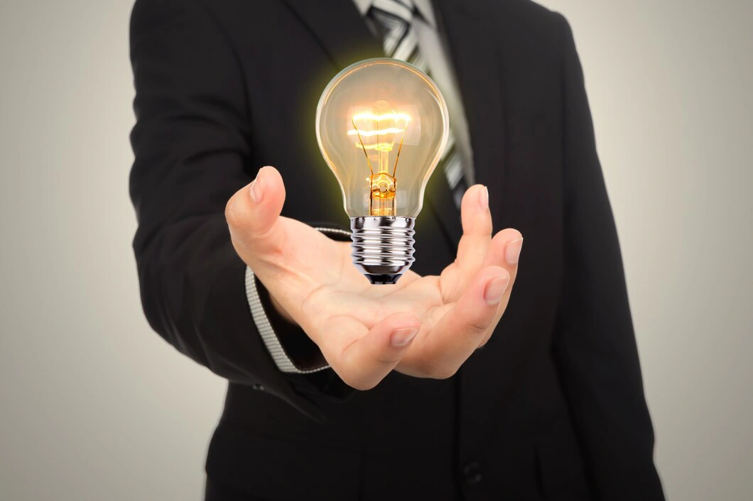 businessman-with-stiffened-hand-lit-light-bulb
